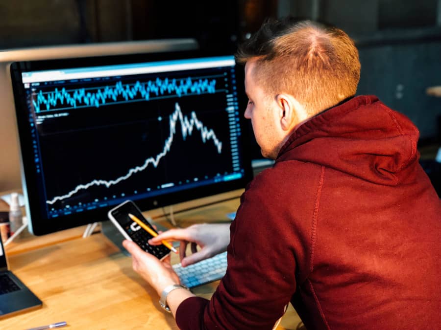 Team of professionals collaborating in a modern office, analyzing charts and discussing strategies, symbolizing SaaS startup business sales optimization.